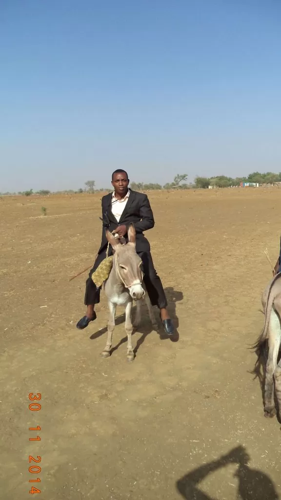 Gen. Coordinator riding on a Donkey in desert of Illela in Sokoto state